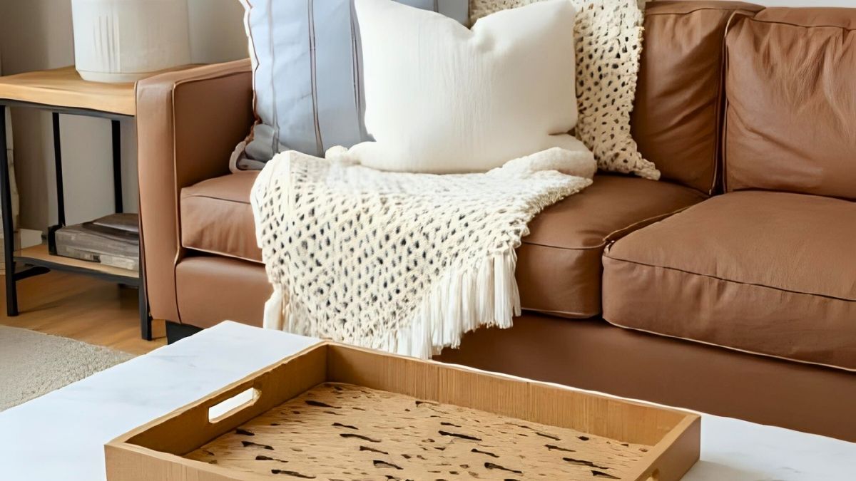 affordable home decor ideas with chunky knit blanket over leather couch in a living room