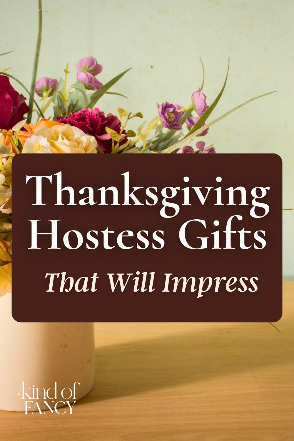 a seasonal fall bouquet in an ivory ceramic vase part of the best hostess gifts for Thanksgiving