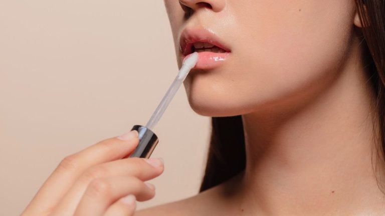 best lip oils being applied to a young woman's face