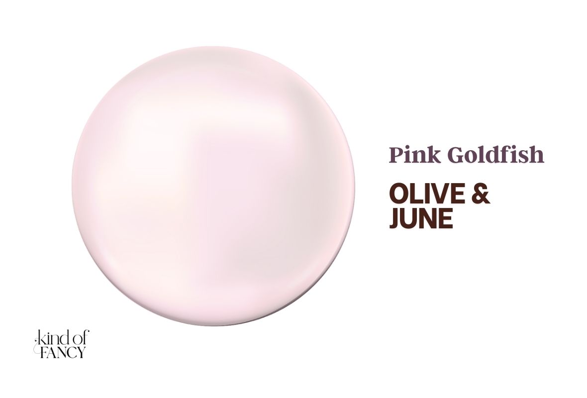 Swatch of Olive & June Pink Goldfish, warm, glowing pearl with the softest gold-pink radiance for luxe winter nails