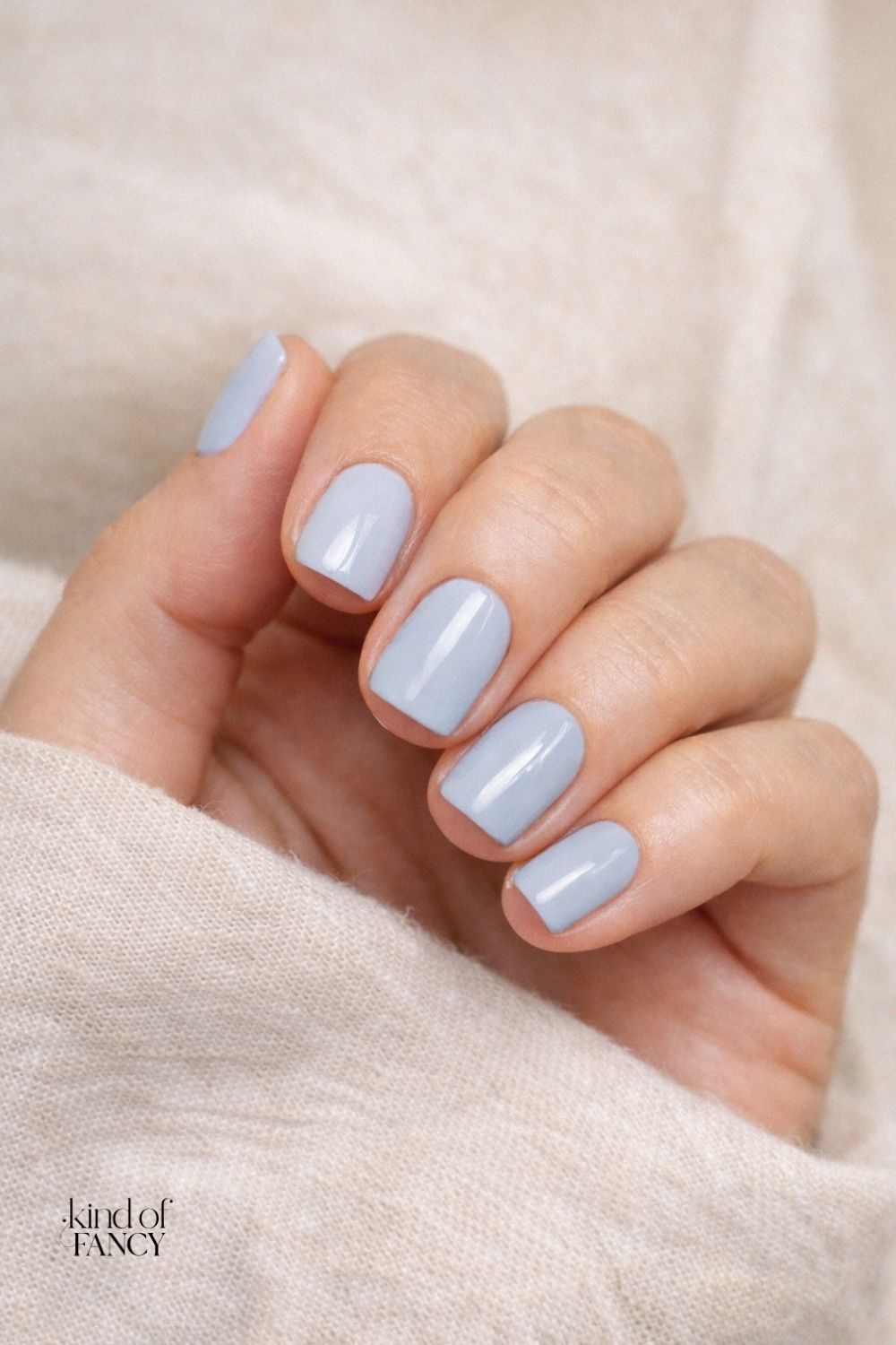 icy blue nails solid color manicure for spring nails that are easy, elegant and grown. A closeup of a manicure in a soft glacier blue color in a wearable spring nail polish.