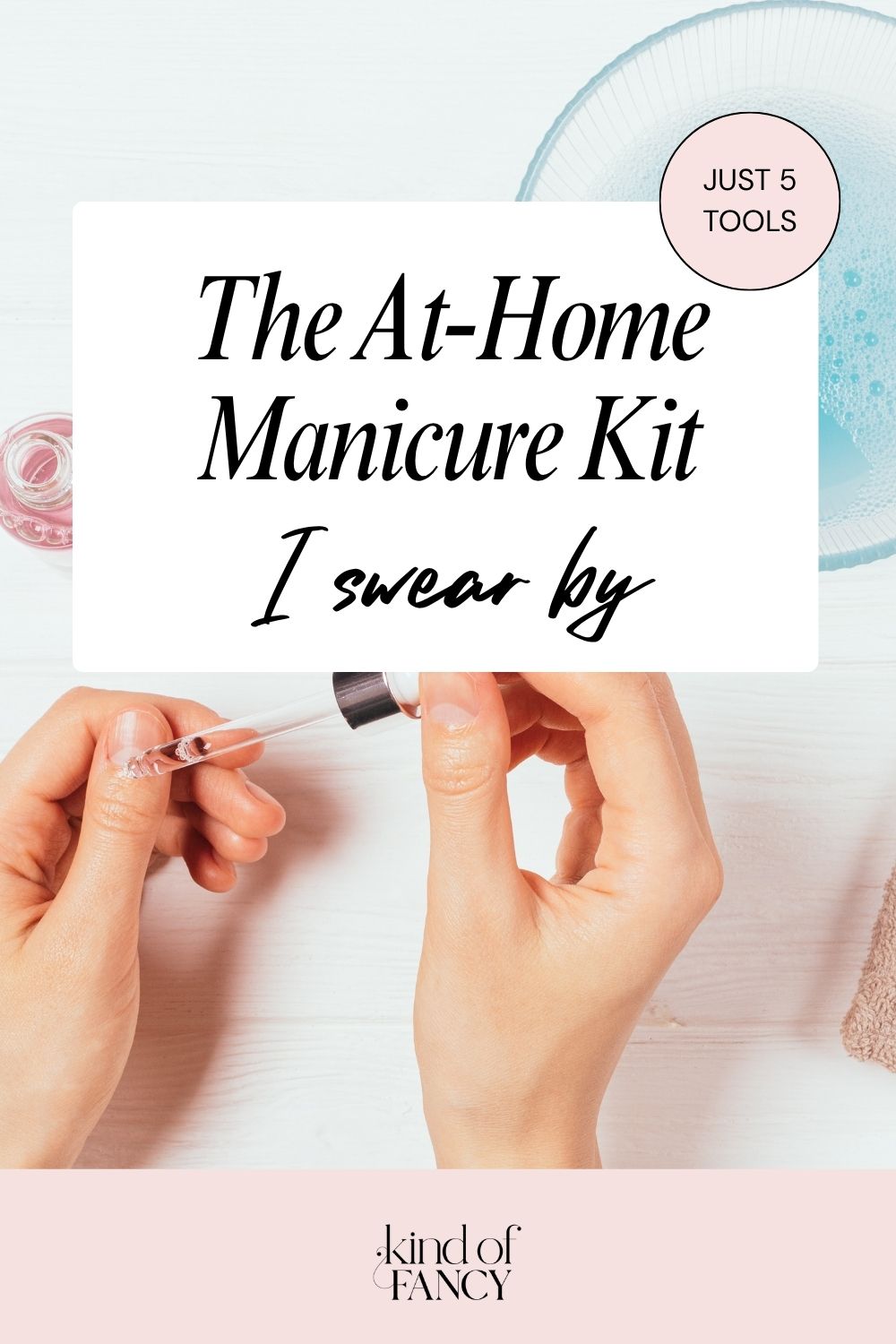 Overhead shot of an at-home manicure kit using nail care tools like a cuticle oil and glass nail file. 
