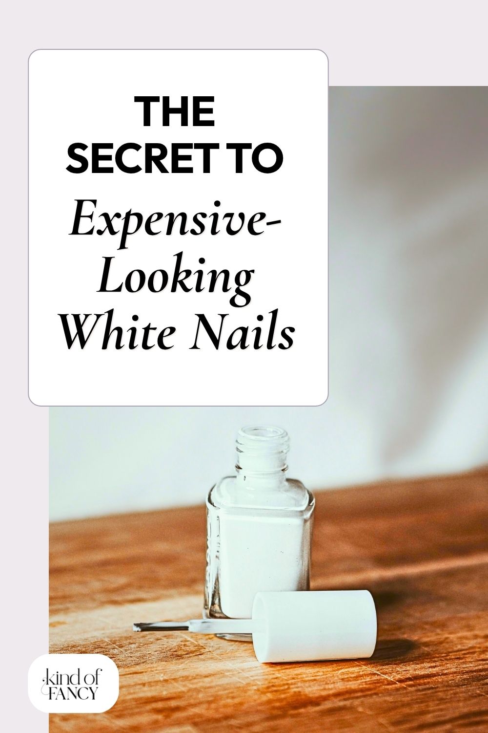 bottle of classy white nail polish on a wooden board in a cozy bedroom with white linens.